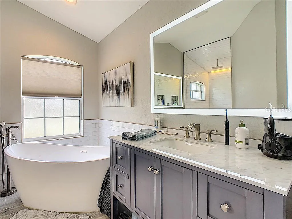 Primary bathroom vanity and tub